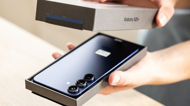 someone unboxing a samsung galaxy S25+ smartphone