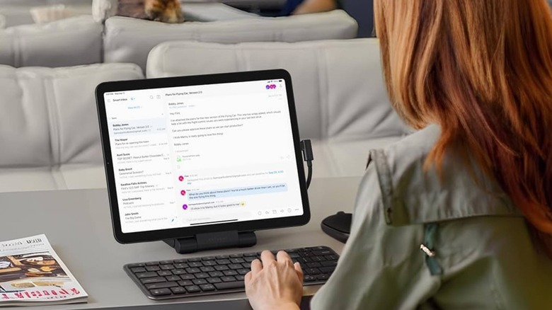 close-up of woman using a Satechi OnTheGo Folding Stand with a wireless keyboard
