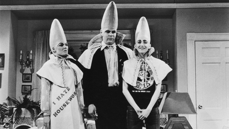 A black and white screenshot from a Coneheads sketch on SNL