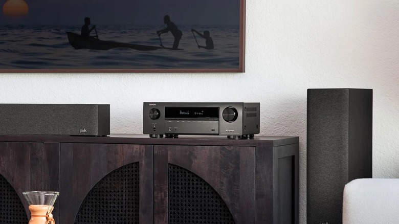 The Denon AVR-X7100H AV Receiver set up on a stand