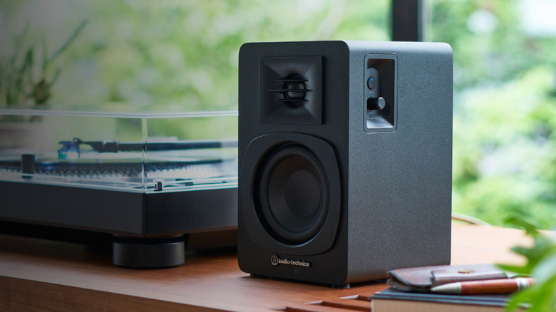 Audio-Technica AT-SP3X bookshelf speaker next to turntable.