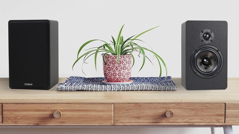 Micca bookshelf speakers on a table
