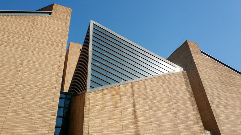 Rammed earth walls and modern glass fixtures up close.