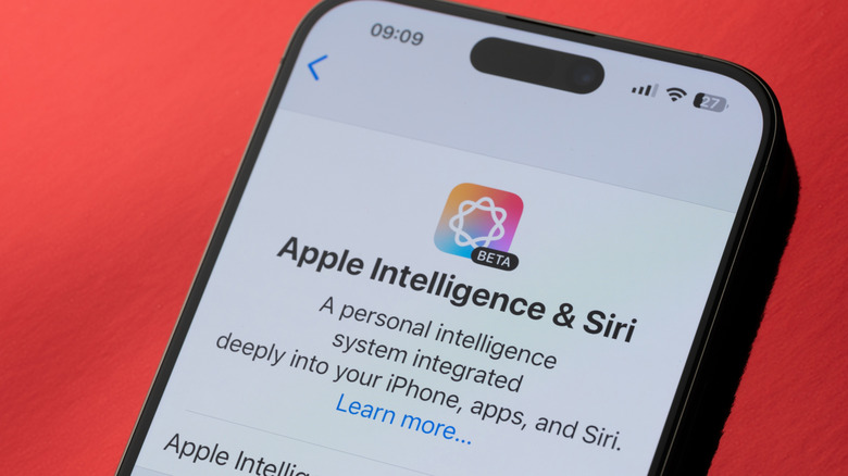 The Apple Intelligence settings menu on an iPhone laying against a red background