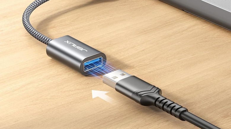 A USB-A cable being plugged into the JSAUX USB OTG adapter.