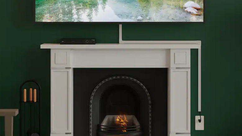 A cord cover kit being used to hide a TV power cord.