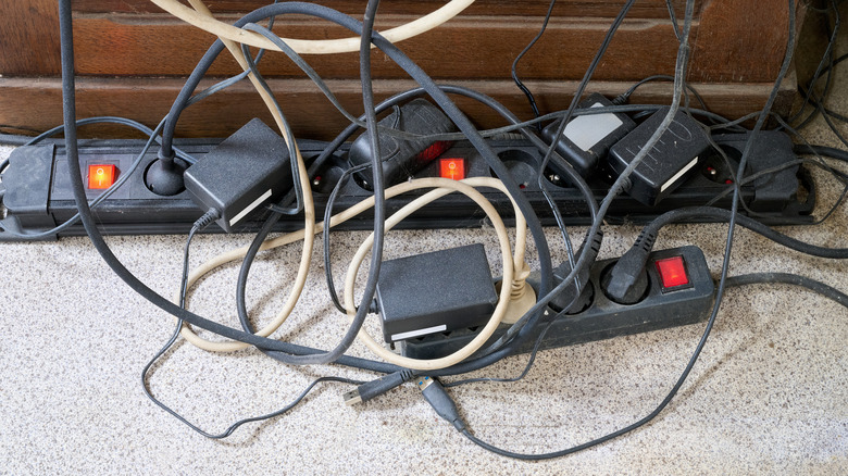 Surge protector and power cables plugged in, in a big mess.