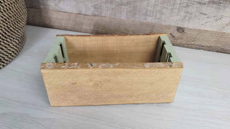 A small box made of wooden components from Dollar Tree.