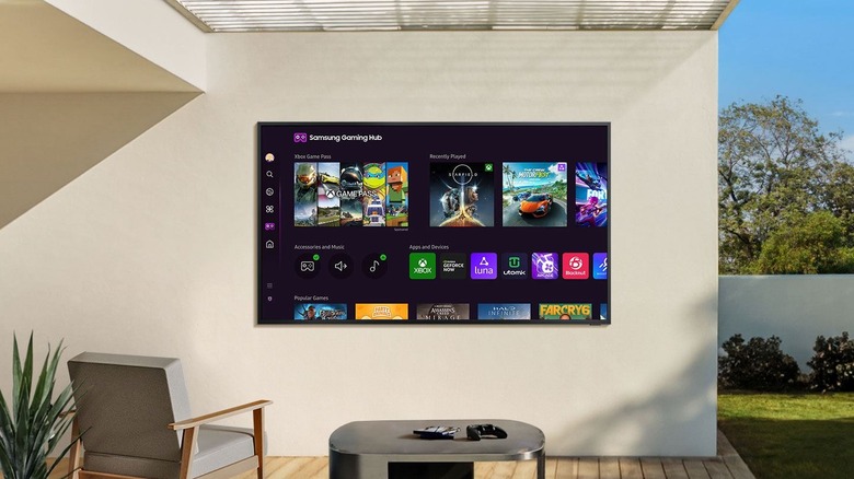 Samsung The Terrace smart TV used outdoors for gaming.