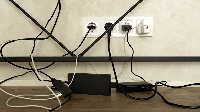 multiple cables causing clutter against a wall