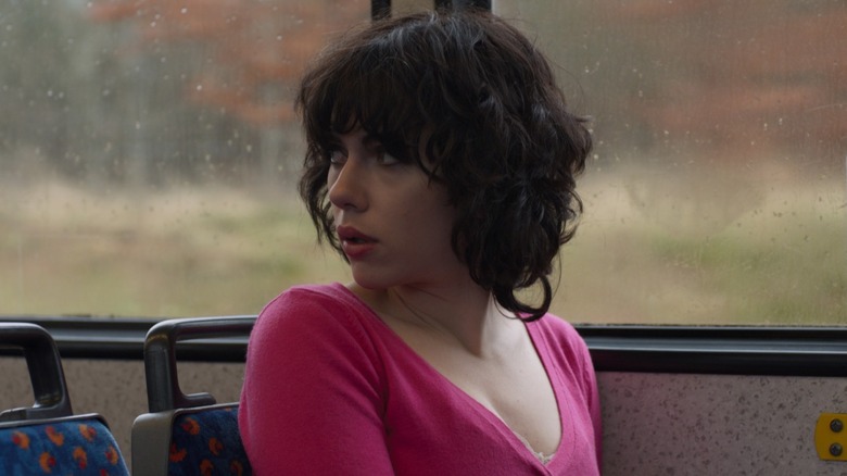 The Female looking behind her on a bus in 
