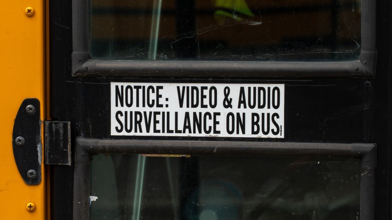 Image of notice of video and audio surveillance on a school bus.