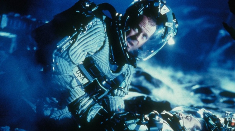 Bruce Willis as Harry Stamper on the floor in a spacesuit in Armageddon