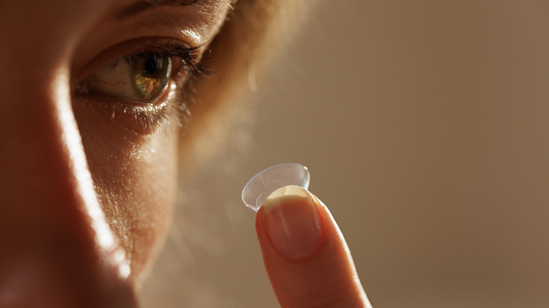 person putting in a contact lense