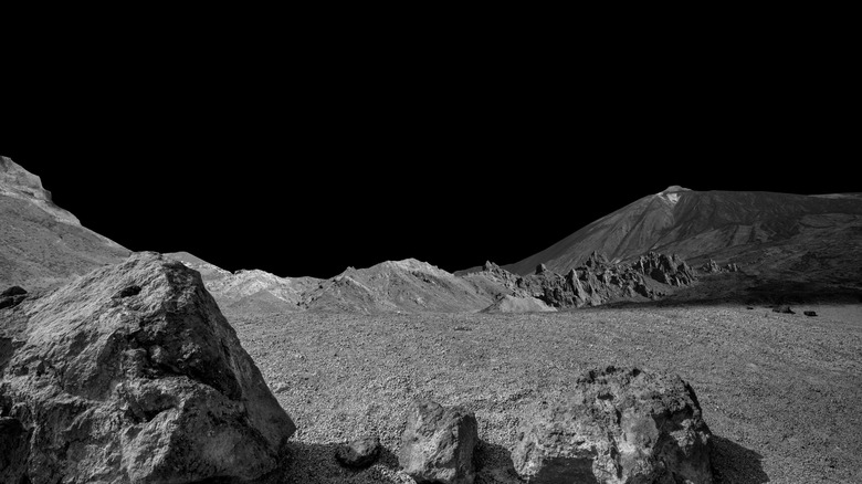 Moon landscape with rocks and lunar hills in the distance