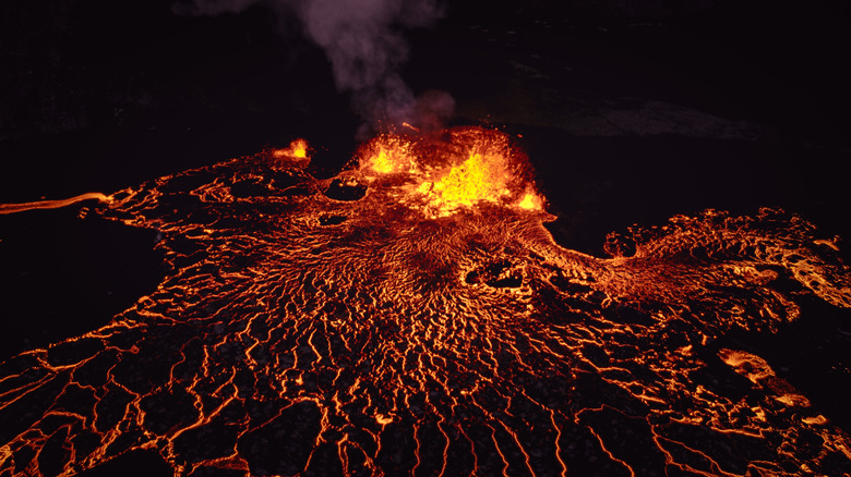 fissure opened in the earth with magma flowing out of it