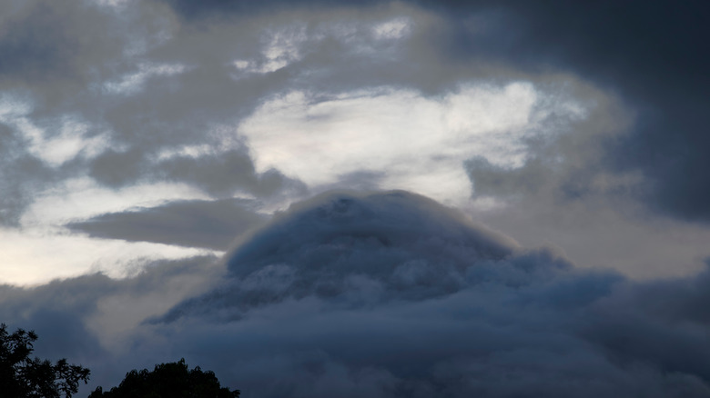 aerial view of a volcano top surrounded by clouds