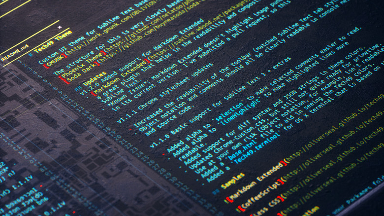 digital screen showing coding text on dark background