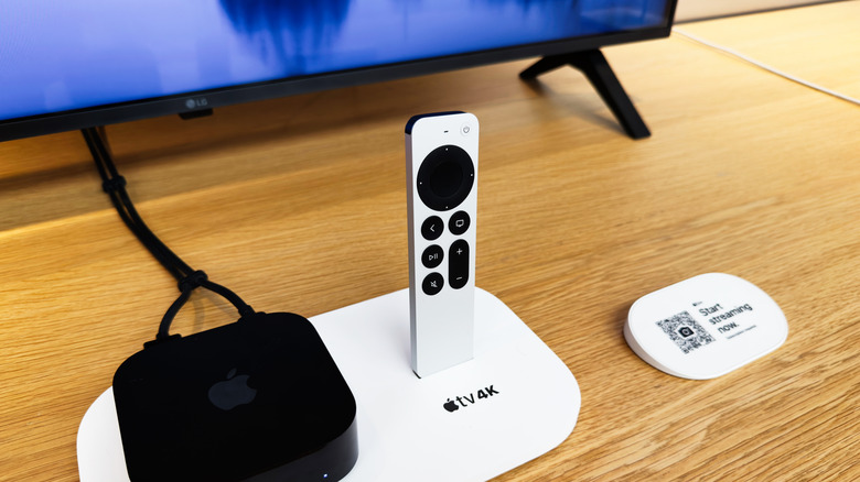 A remote placed near an Apple TV 4K connected to a screen