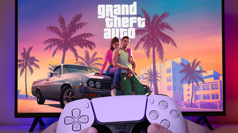 PS5 DualSense controller in front of a TV with Grand Theft Auto 6 cover art