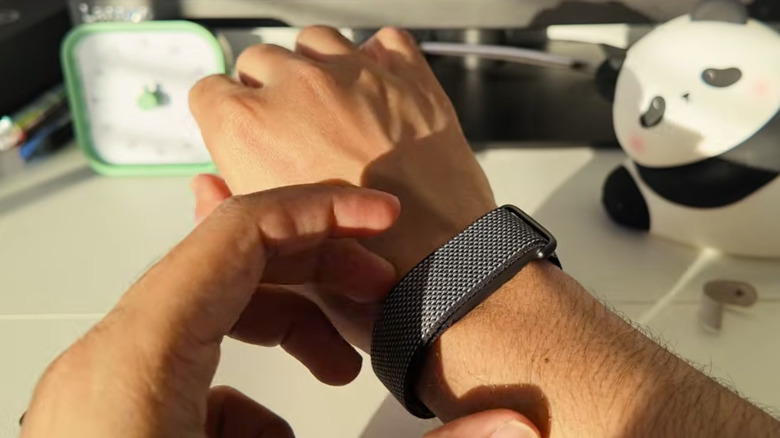 the Google Fitbit Air on a man's wrist