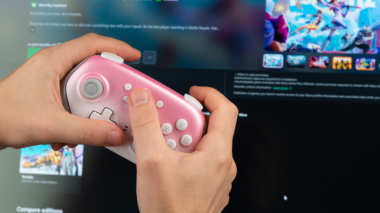 A controller is being used to navigate a console game store.