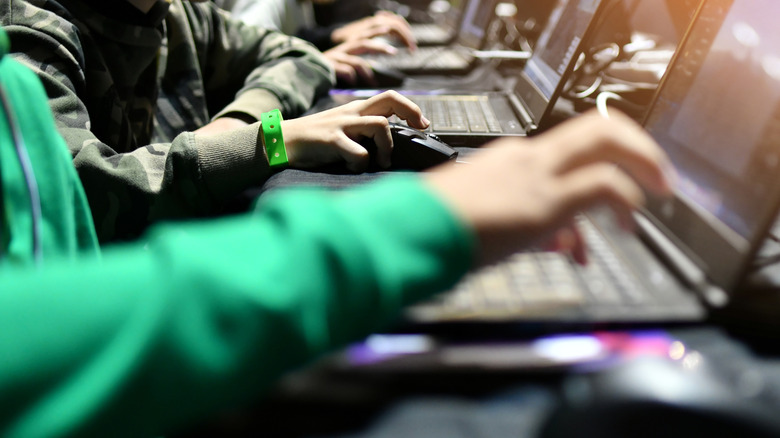 A row of laptop gamers get into gear.