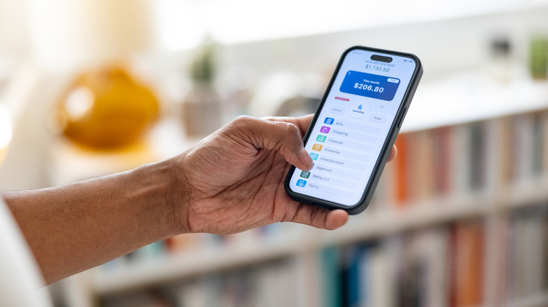 A person using a phone app to check their bank account balance