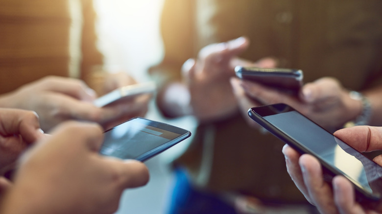A group of people using phones together