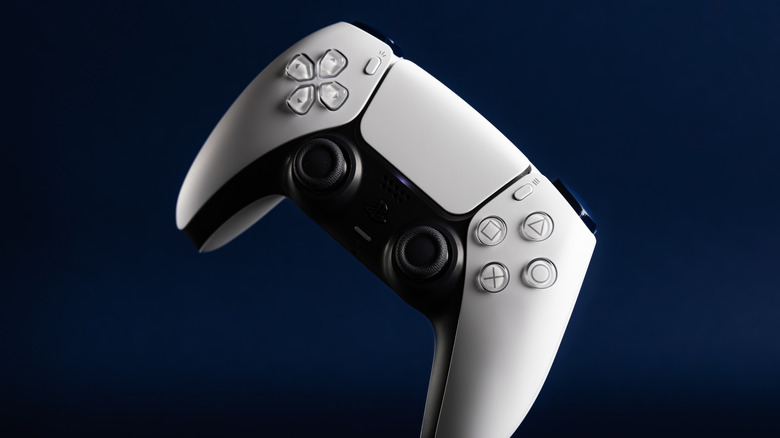 The PS5 DualSense controller set against a navy blue backdrop.