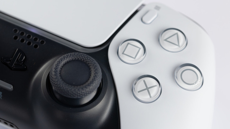 A close-up image of the shape buttons and right joystick of the DualSense controller.