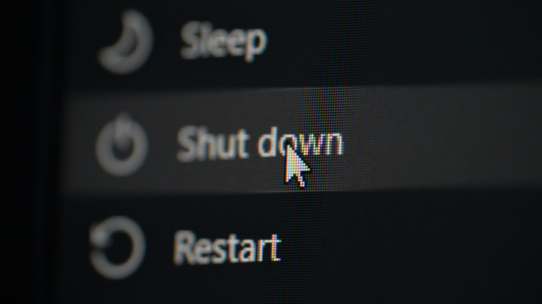A close up of clicking the shut down option on a windows computer