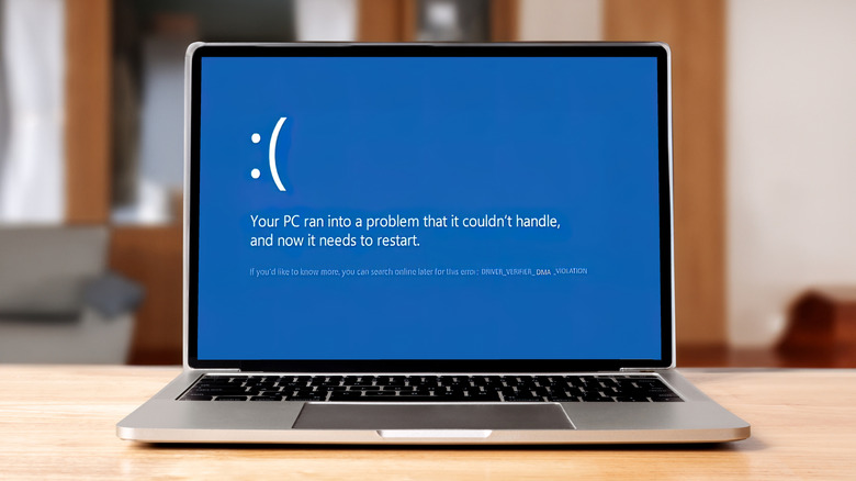 Windows 11 blue screen showing warning on laptop
