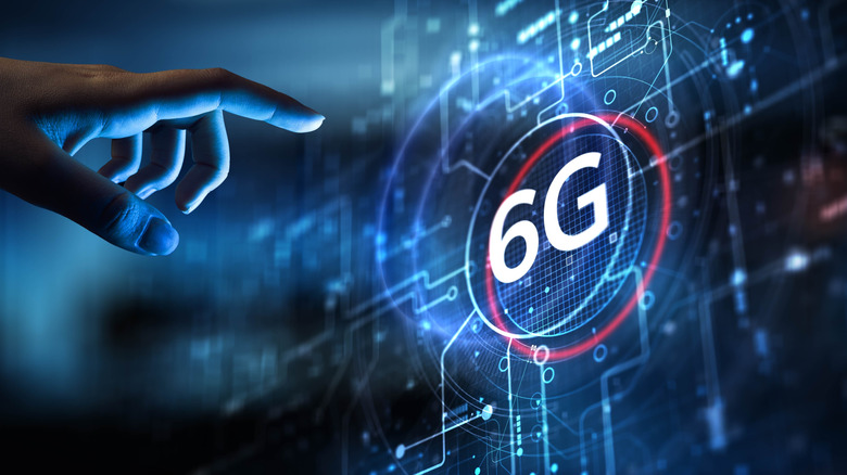 hand reaching out to an illustrated conception of 6G