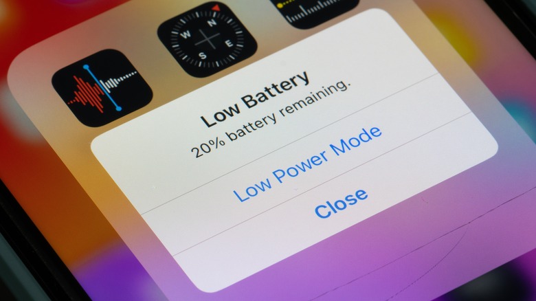 An iPhone displaying the Low Battery warning within iOS, the message reads 20% battery remaining and has the options for Low Power Mode and Close