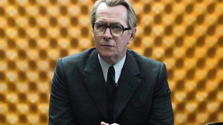 George Smiley sitting and looking seriously