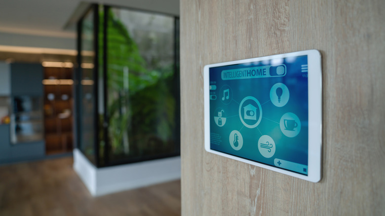 Smart home control panel, and tablet, mounted to a wall.