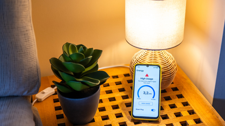 Smart home lamp controlled by a phone app showing energy usage data