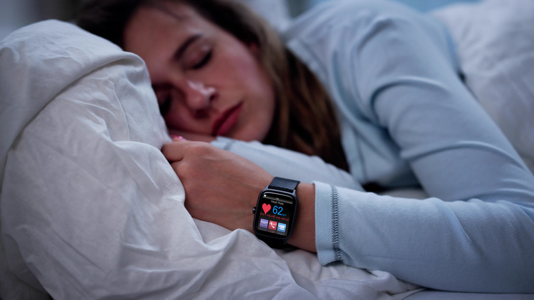A sleeping woman wearing a smartwatch