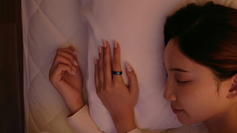 A sleeping woman wearing a smart ring