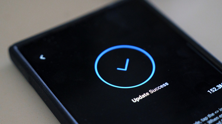 Close up of a smartphone screen showing 'update success' message.