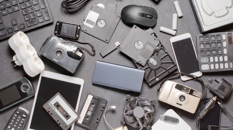 A bunch of tech gadgets littering a floor space.