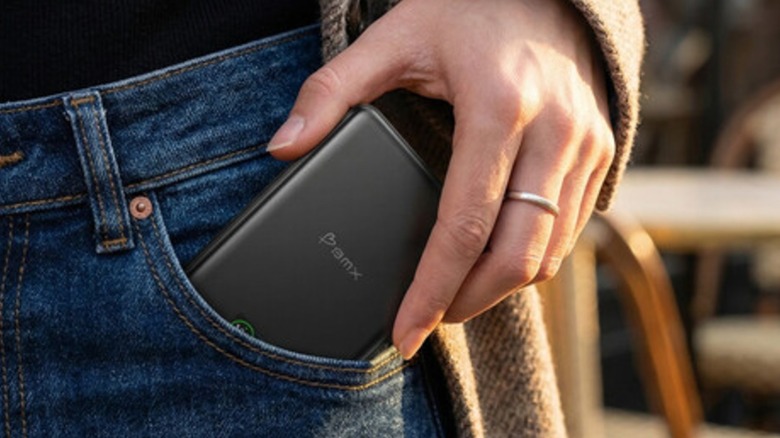 Man taking BMX SolidSafe solid-state battery power bank out of pants pocket