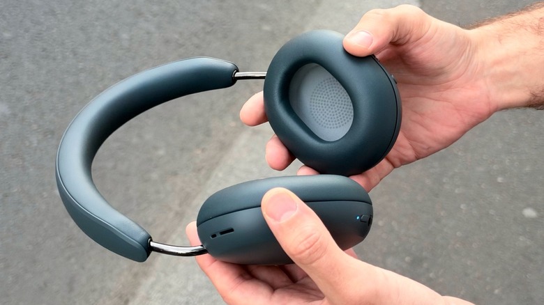 Man holding Sonos Ace Ultra on the street