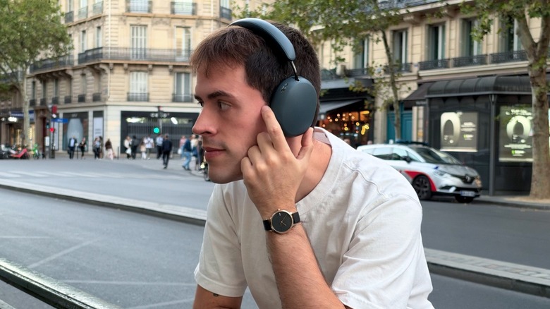 Man wearing Sonos Ace Ultra headphones in outdoor environment