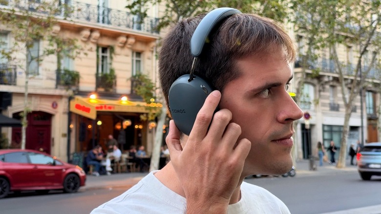 Man wearing Sonos Ace Ultra headphones in outdoor environment