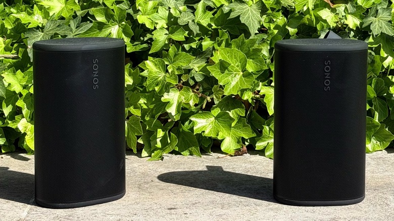 A pair of Sonos Play speakers near some plants