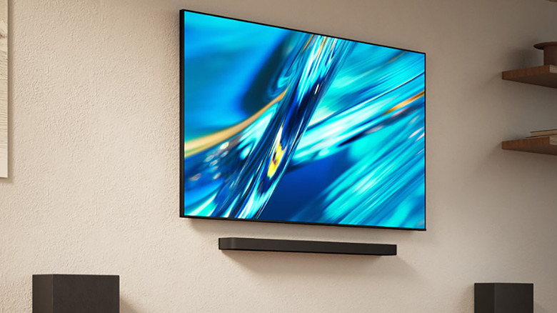 An angled photo of the Sony Bravia 3 II with a soundbar underneath mounted on a wall.