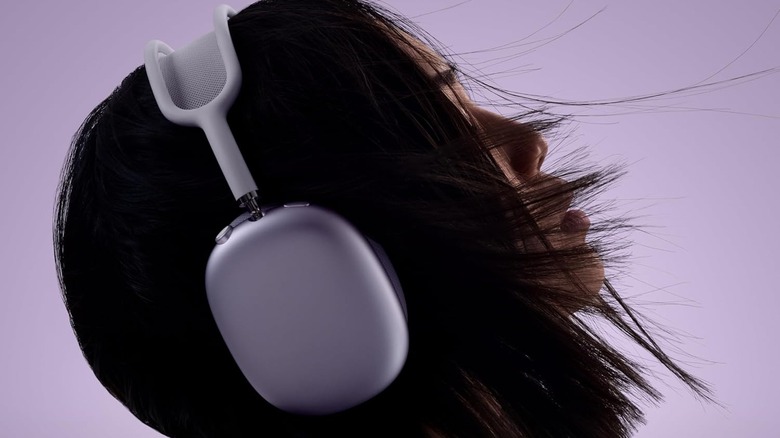 A woman wearing a pair of the Apple AirPods Max 2 headphones.