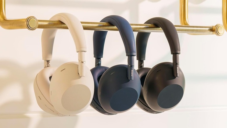 Three pairs of the Sony WH-1000XM6 headphones hung along a towel rack.